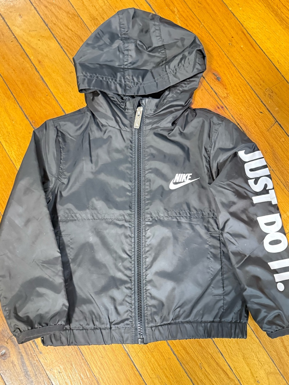 Nike Kids Black Hooded Wind Breaker Jacket with White 'Just Do It.' Sleeve